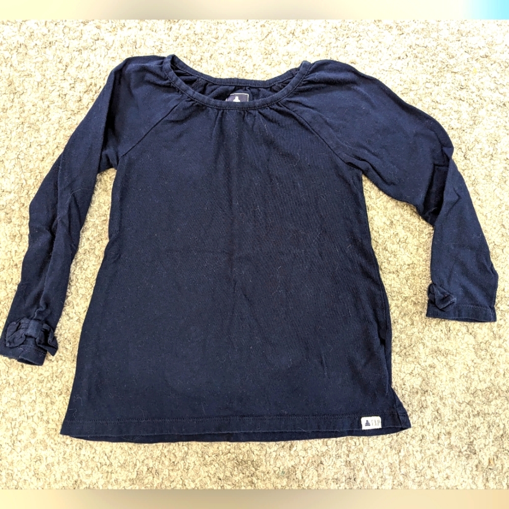 2/$18. Gap girls dark blue long sleeve shirt. EUC. Bow at wrists. 4yrs.